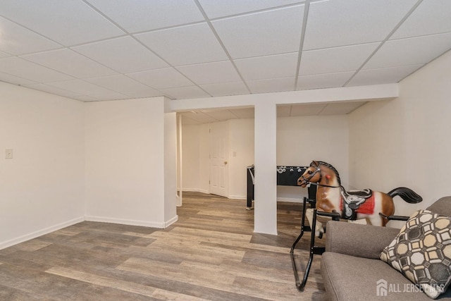 interior space with wood-type flooring and a drop ceiling