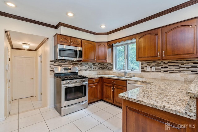 kitchen featuring sink, light stone counters, crown molding, light tile patterned floors, and stainless steel appliances