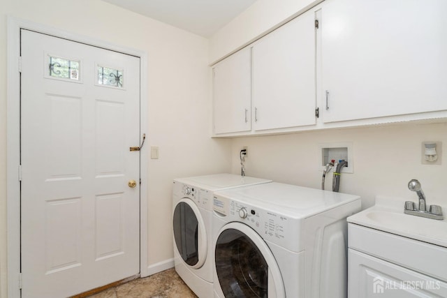 washroom featuring separate washer and dryer, sink, and cabinets