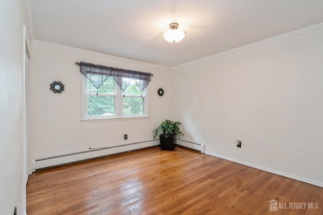 unfurnished room featuring a baseboard heating unit, light hardwood / wood-style flooring, and ornamental molding