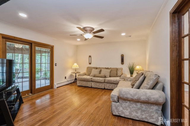 living room featuring crown molding, light hardwood / wood-style floors, ceiling fan, and baseboard heating