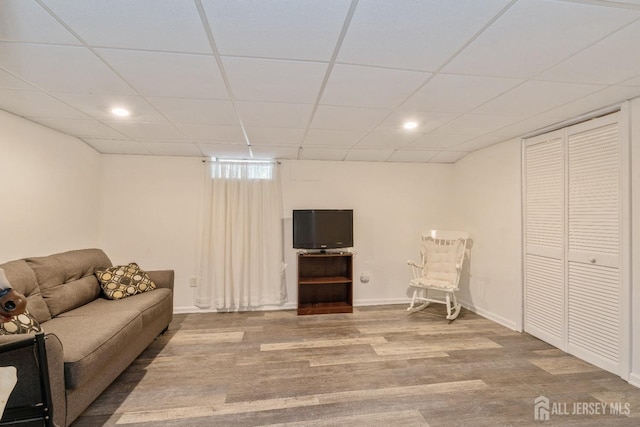 sitting room with a paneled ceiling and hardwood / wood-style floors