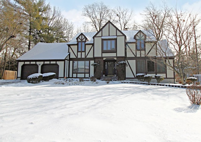 tudor house featuring a garage