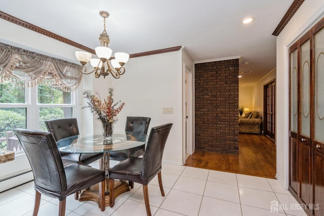 dining room with crown molding, light tile patterned floors, and a chandelier