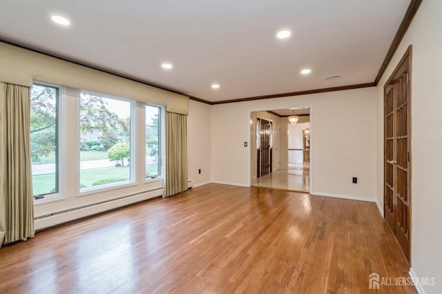 unfurnished room featuring crown molding, light hardwood / wood-style flooring, and a baseboard heating unit