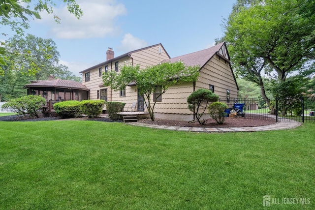 back of house featuring a gazebo and a lawn