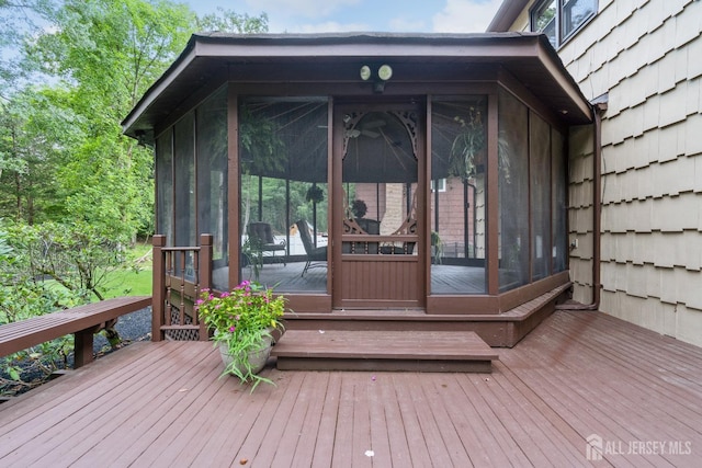 wooden deck featuring a sunroom