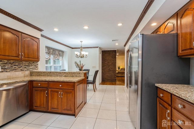 kitchen with light stone counters, light tile patterned floors, ornamental molding, stainless steel appliances, and backsplash