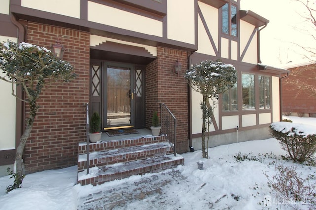 view of snow covered property entrance