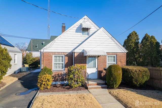 bungalow-style house with cooling unit