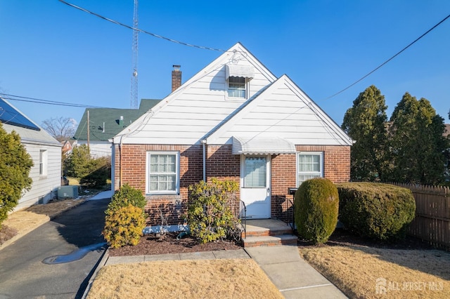 bungalow-style house featuring cooling unit