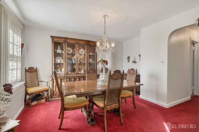 dining room with a chandelier, carpet, and a healthy amount of sunlight