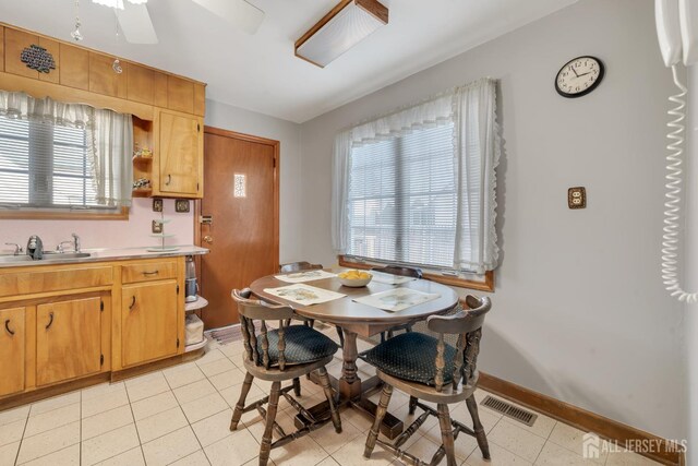 tiled dining room featuring sink