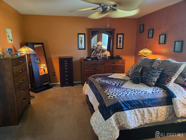 bedroom featuring ceiling fan and carpet