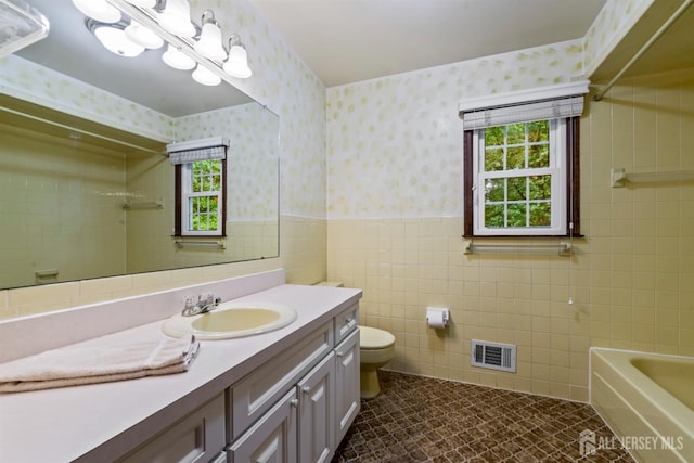 19 Redcoat Dr, East Brunswick, NJ 08816 - bathroom with wallpapered walls, wainscoting, vanity, a bathtub, and a shower