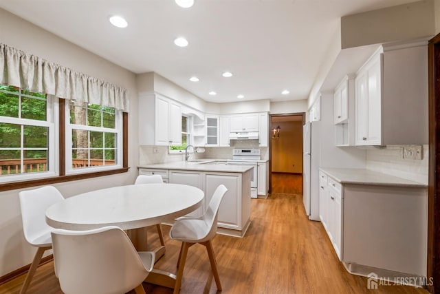 19 Redcoat Dr, East Brunswick, NJ 08816 - kitchen with white appliances, decorative backsplash, light wood-style flooring, light countertops, and recessed lighting