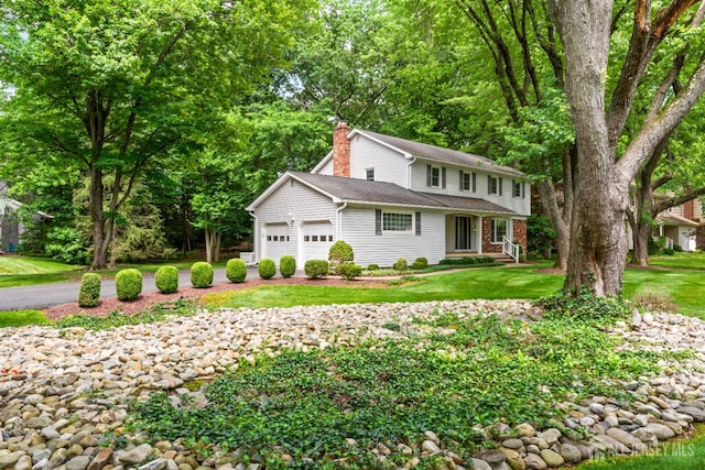 19 Redcoat Dr, East Brunswick, NJ 08816 - traditional home featuring a garage, a front yard, a chimney, and driveway