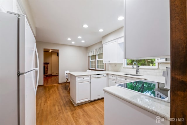 19 Redcoat Dr, East Brunswick, NJ 08816 - kitchen featuring white appliances, a peninsula, light wood-style flooring, white cabinetry, and recessed lighting