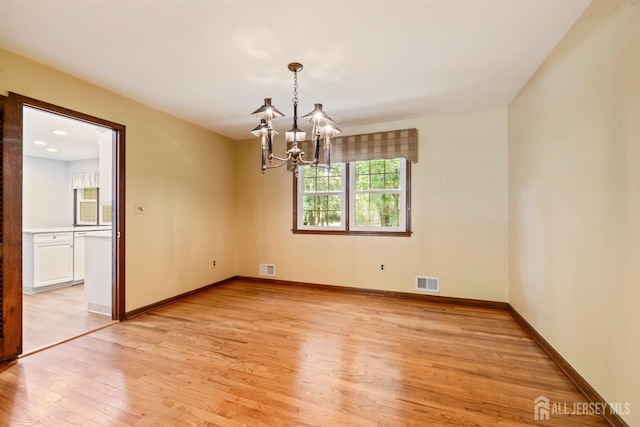 19 Redcoat Dr, East Brunswick, NJ 08816 - empty room with a chandelier and light wood-style flooring