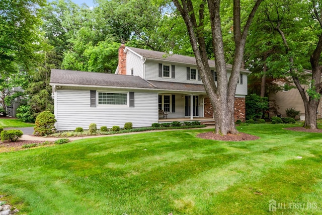 19 Redcoat Dr, East Brunswick, NJ 08816 - traditional-style house with a chimney, a porch, a front lawn, and a shingled roof
