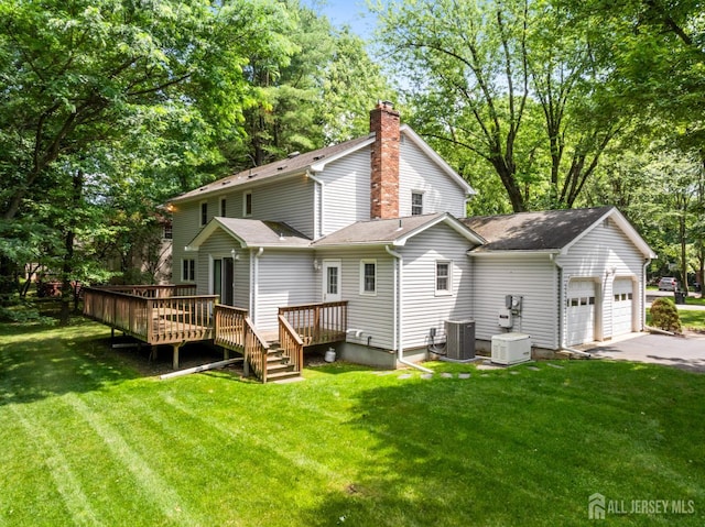 19 Redcoat Dr, East Brunswick, NJ 08816 - rear view of house featuring a deck, a yard, a garage, and view of wooded area
