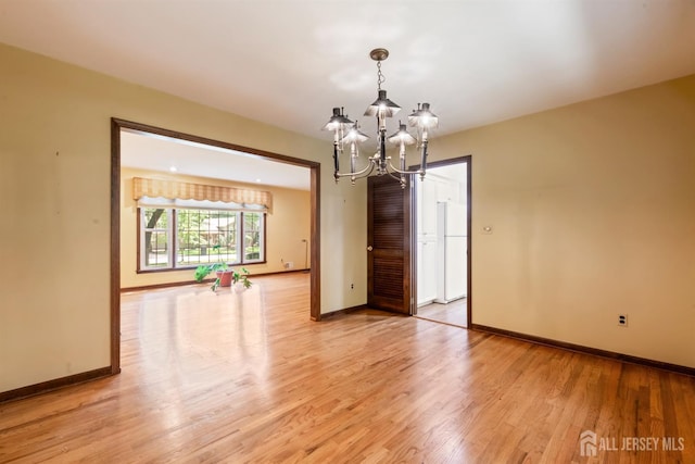 19 Redcoat Dr, East Brunswick, NJ 08816 - unfurnished room featuring a chandelier and light wood-type flooring