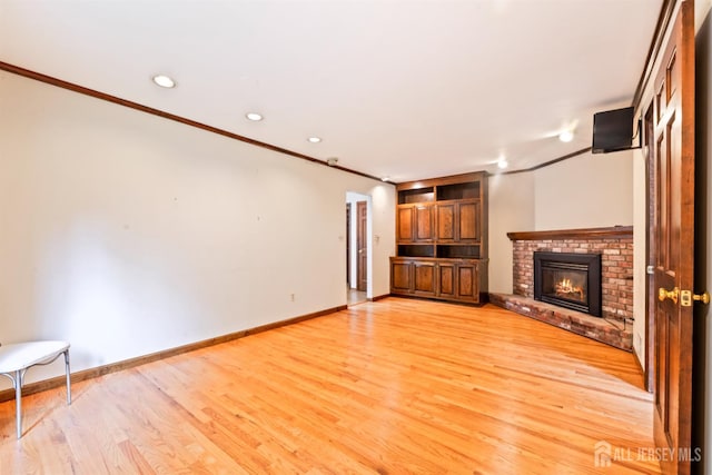 19 Redcoat Dr, East Brunswick, NJ 08816 - unfurnished living room with ornamental molding, a brick fireplace, light wood-style floors, and recessed lighting