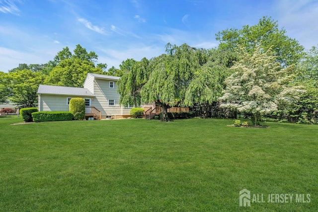 27 Appleby Ln, East Brunswick, NJ 08816 - view of green lawn with a wooden deck