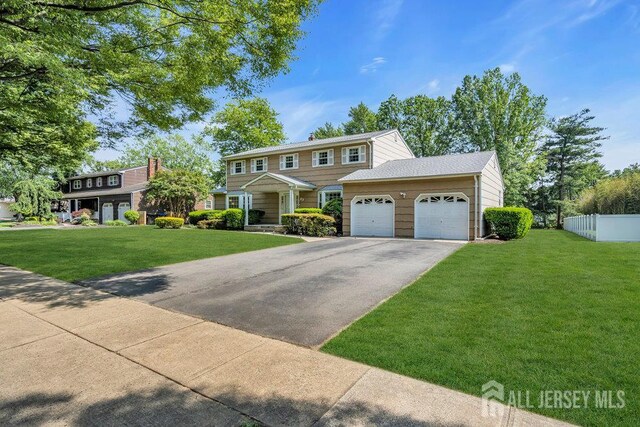 27 Appleby Ln, East Brunswick, NJ 08816 - view of front facade with asphalt driveway and a garage