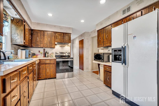 27 Appleby Ln, East Brunswick, NJ 08816 - kitchen featuring stainless steel appliances, light countertops, ventilation hood, brown cabinets, and recessed lighting