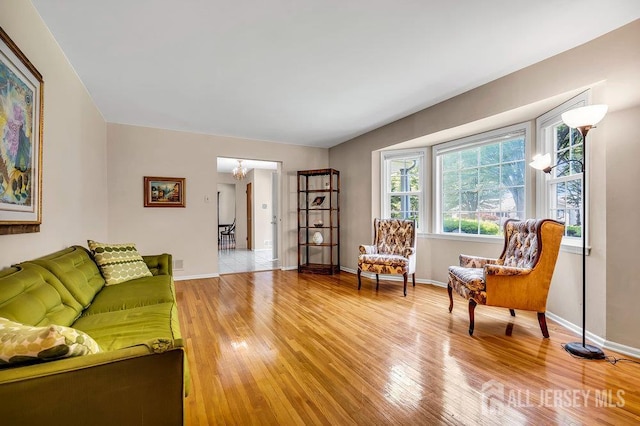 27 Appleby Ln, East Brunswick, NJ 08816 - living room featuring light wood-type flooring and a chandelier