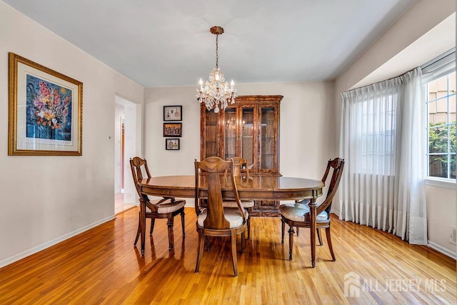 27 Appleby Ln, East Brunswick, NJ 08816 - dining space with light wood-type flooring and a chandelier
