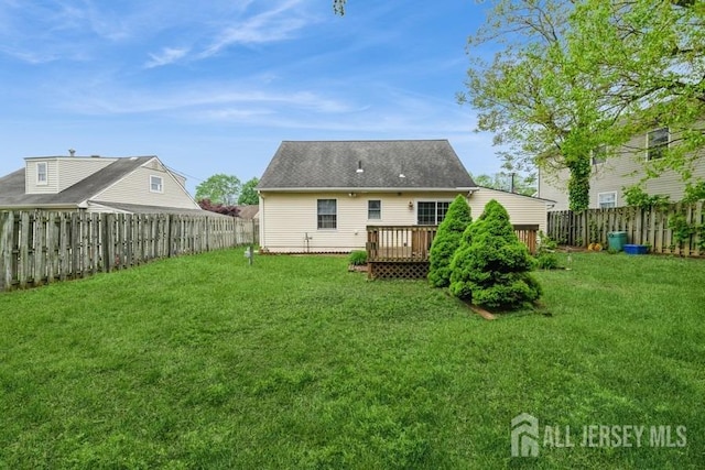 rear view of property featuring a wooden deck