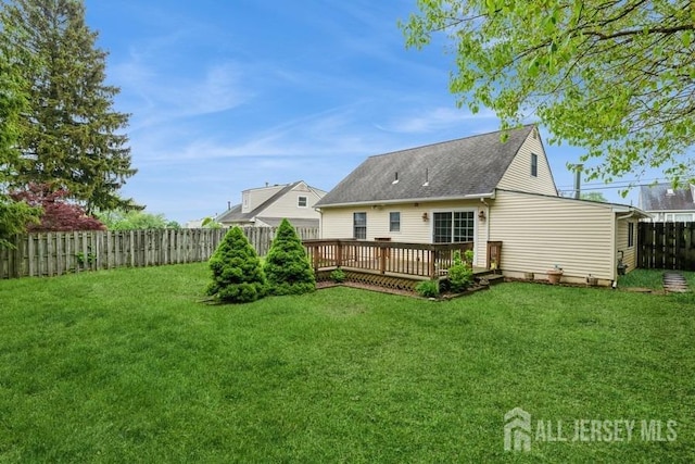 rear view of property with a wooden deck and roof with shingles