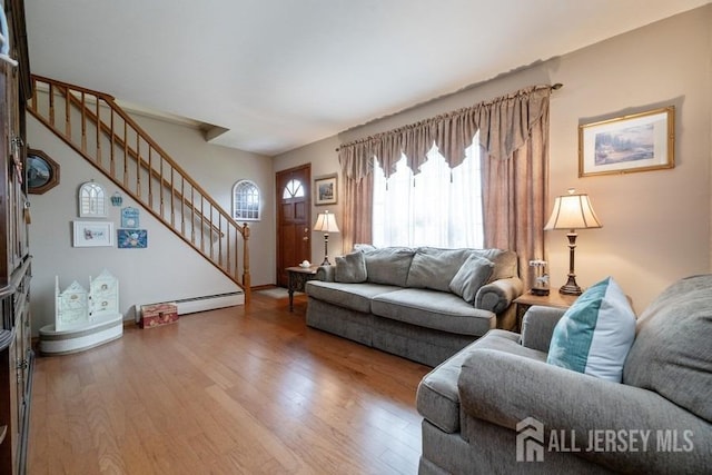 living area featuring stairs and wood finished floors