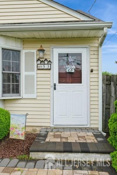 doorway to property with fence