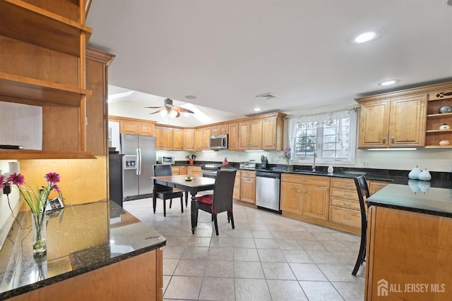 kitchen with dark stone countertops, a ceiling fan, open shelves, a sink, and stainless steel appliances