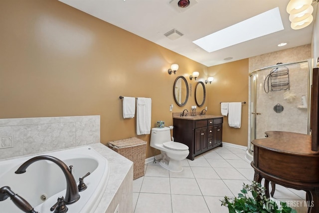 bathroom featuring visible vents, a jetted tub, a skylight, a shower stall, and tile patterned flooring