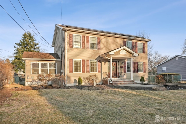 view of front facade with solar panels, a front yard, and fence