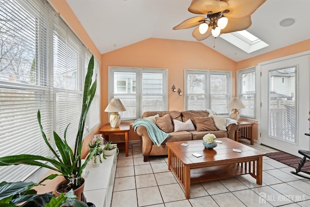 sunroom with vaulted ceiling with skylight and a ceiling fan