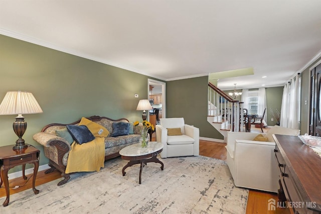 living area with a notable chandelier, stairway, crown molding, and wood finished floors