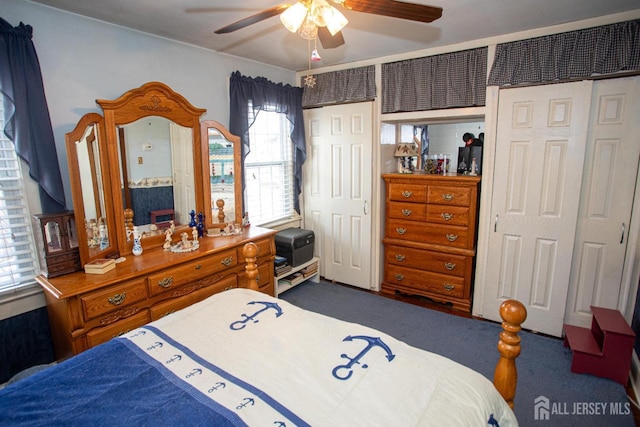 bedroom with dark colored carpet and ceiling fan