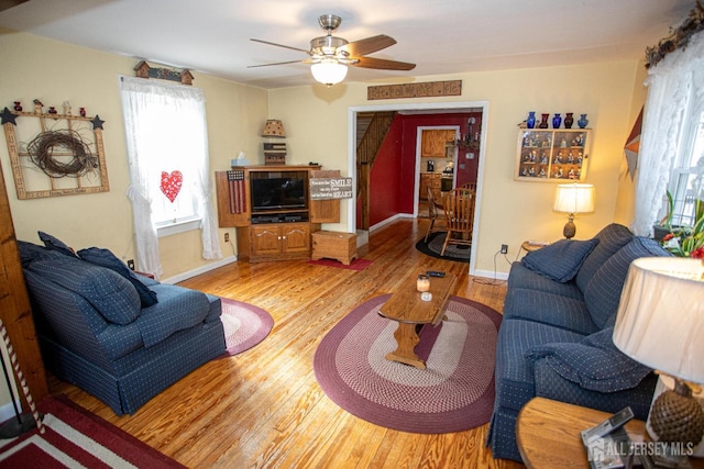 living room featuring ceiling fan and light wood-type flooring