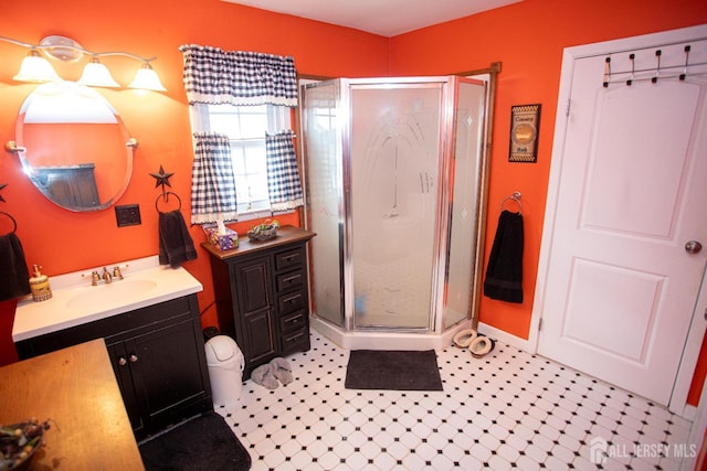 bathroom featuring vanity and an enclosed shower