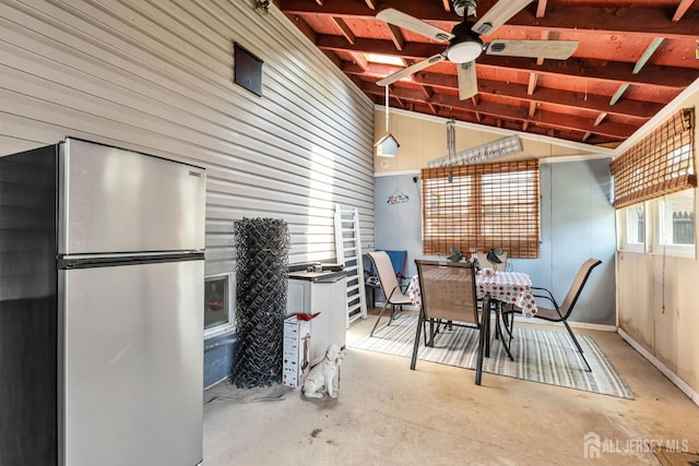 164 Holly St, Port Reading, NJ 07064 - dining room with unfinished concrete flooring, ceiling fan, wood walls, and high vaulted ceiling