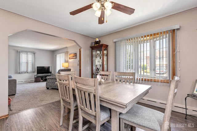 164 Holly St, Port Reading, NJ 07064 - dining area with healthy amount of natural light, a ceiling fan, arched walkways, and wood finished floors