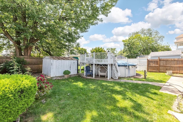 164 Holly St, Port Reading, NJ 07064 - fenced backyard featuring a storage unit and a wooden deck
