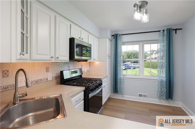 416 Wallace St Unit 416, Edison, NJ 08817 - kitchen with appliances with stainless steel finishes, a sink, light countertops, and white cabinets