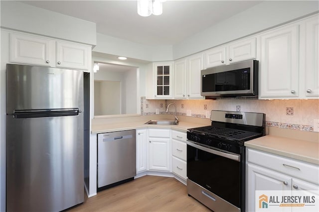 416 Wallace St Unit 416, Edison, NJ 08817 - kitchen with appliances with stainless steel finishes, a sink, glass insert cabinets, white cabinets, and recessed lighting