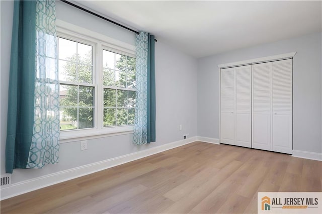 416 Wallace St Unit 416, Edison, NJ 08817 - unfurnished bedroom featuring wood finished floors, baseboards, and a closet